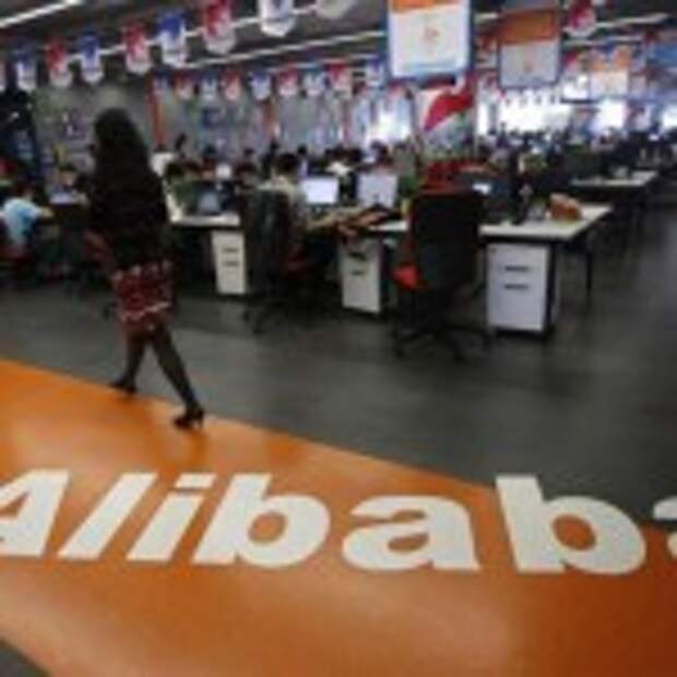 An employee walks past a logo of Alibaba Group at its headquarters on the outskirts of Hangzhou, Zhejiang province, in this May 17, 2010 file photo. REUTERS/Stringer/Files