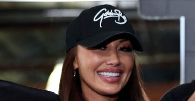 Holly Sonders smiling at baseball game