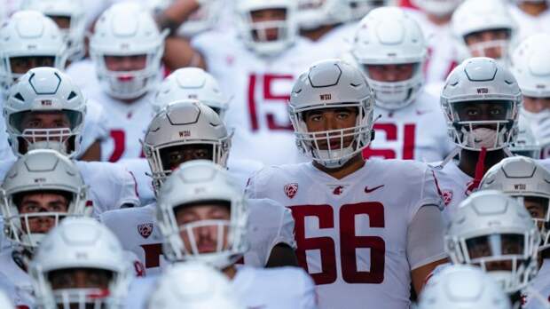 Washington State football players come out of the tunnel before a game.