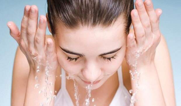 Fresh and lovely woman washing her face