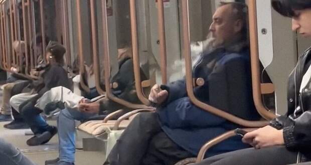 Мужчина закурил во время поездки в метро