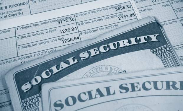 Two Social Security cards on top of a tax document.