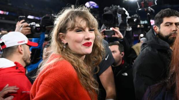 Taylor Swift on the field with the Chiefs after the AFC Championship.