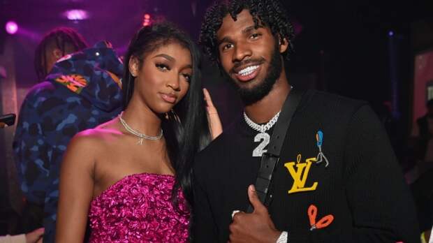 Shedeur Sanders poses for a photo with LSU women's basketball player Angel Reese at her birthday party.