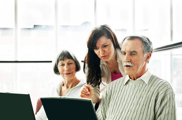 Three people looking at computer screens.