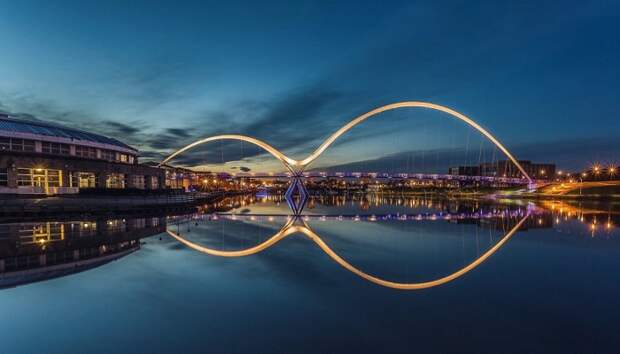 В ночное время благодаря подсветке и днем, когда полный штиль, пешеходный мост, отражаясь в воде имеет вид знака бесконечности (Мост Infinity, Англия). | Фото: liveinternet.ru.