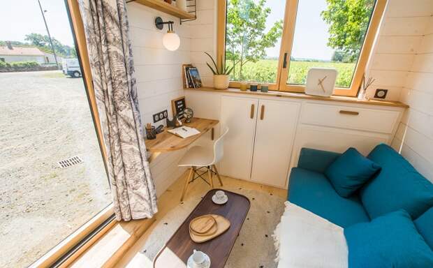 Многофункциональная гостиная позволит отдохнуть, наслаждаясь пейзажем за панорамным окном и плодотворно поработать (модель The ia Orana). | Фото: tinyhouse-baluchon.fr. Многофункциональная гостиная позволит отдохнуть, наслаждаясь пейзажем за панорамным окном и плодотворно поработать (модель The ia Orana). | Фото: tinyhouse-baluchon.fr.