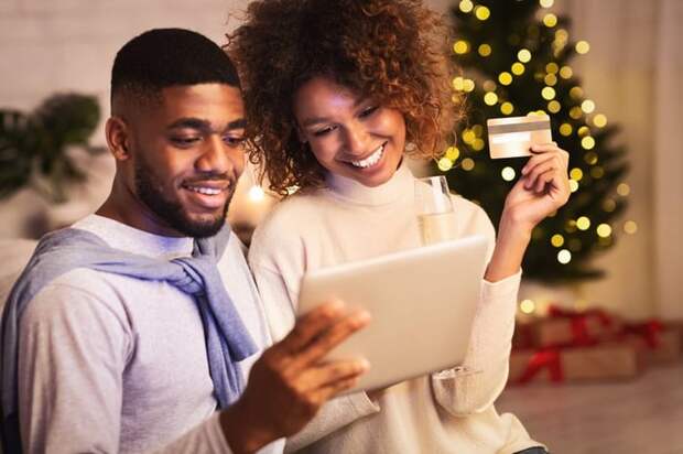 A couple shops online with a credit card during the holiday season