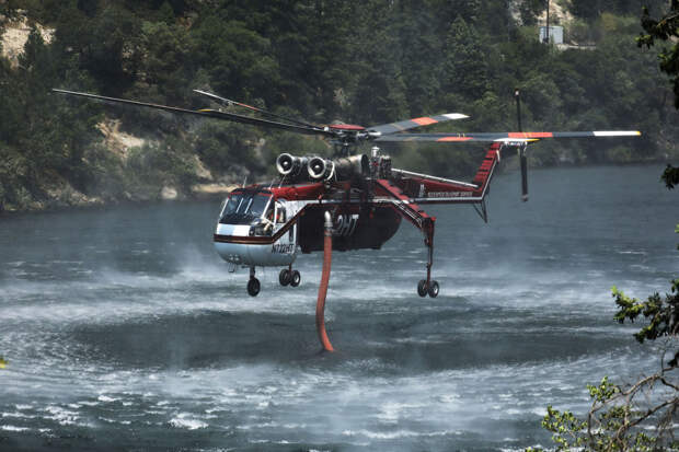 Пожарный вертолет набирает воду