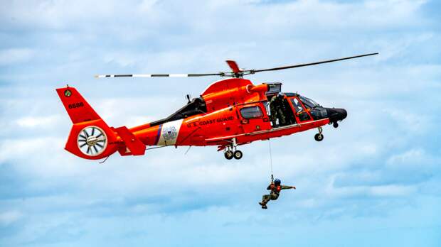 Coast Guard Dramatically Rescues 3 Men Fighting Off Sharks After Arriving 'In The Nick Of Time'