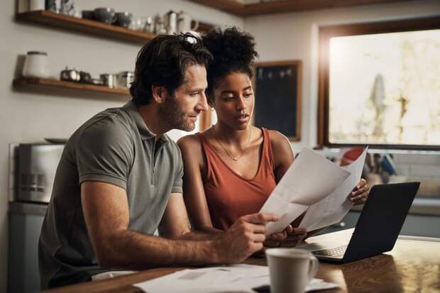 Two people looking at documents together.
