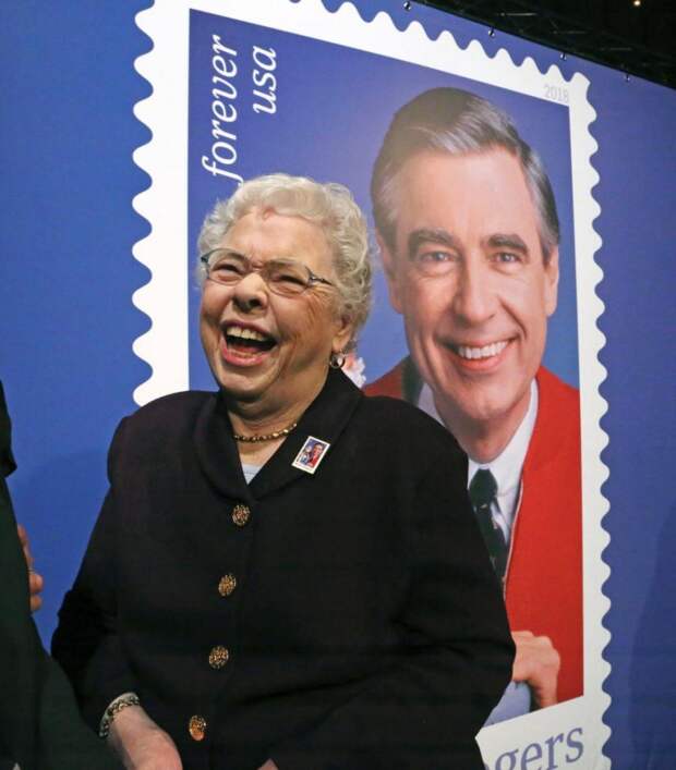 Fred Rogers wife, Joanne Rogers, shares a laugh with friends in front of a giant Mister Rogers Forever Stamp following the first-day-of-issue dedication in WQED's Fred Rogers Studio in Pittsburgh, Friday, March 23, 2018. (AP Photo/Gene J. Puskar)