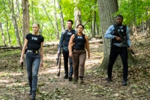 The FBI is armed as the agents walk through the woods to capture an ecoterrorist on FBI: Most Wanted Season 6 Episode 3
