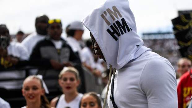 Travis Hunter walks onto the field before a Colorado football game.