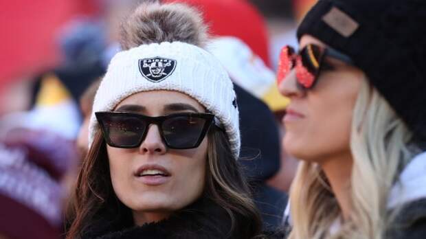 Raiders fans react to a play on the field.