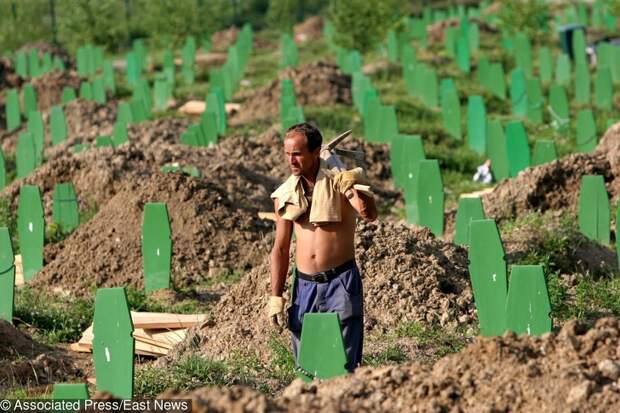 Grave digger walks through the cemetary in Potocari, outside Srebrenica Friday July 8 2005. Bodies of 613 people discovered in mass graves in Bosnia will be burried Monday on the tenth anniversary Bosnian Serb forces antering Srebrenica. Toward the end of Bosnia's 1992-95 war, as many as 8,000 Bosnian Muslim men and boys were killed when Bosnian Serb troops overran the eastern Bosnian enclave of Srebrenica July 11, 1995. It was Europe's worst mass killing since World War II. (AP Photo/Dusan Vranic)