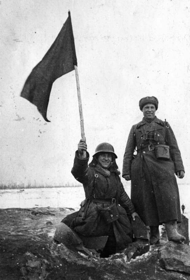 Герой Советского Союза лейтенант Михаил Сипович (слева, в разрушенном наблюдательном колпаке) и капитан Иван Коровин на захваченном финском ДОТе, середина февраля 1940 года