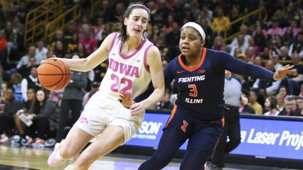 Caitlin Clark drives the ball against an Illinois defender.