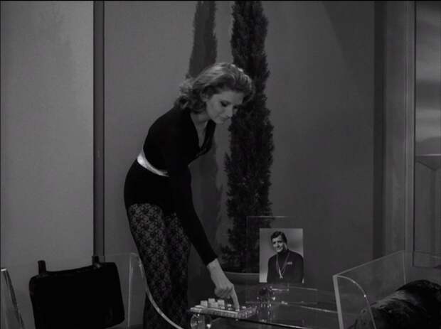 A woman standing by a phone on The Twilight Zone