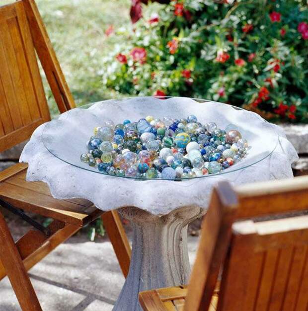 Bird-bath table with marble collection under a glass top
