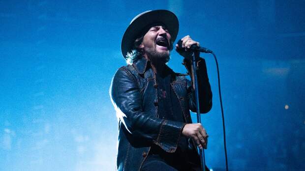 Pearl Jam's Eddie Vedder sings on stage with a mic stand