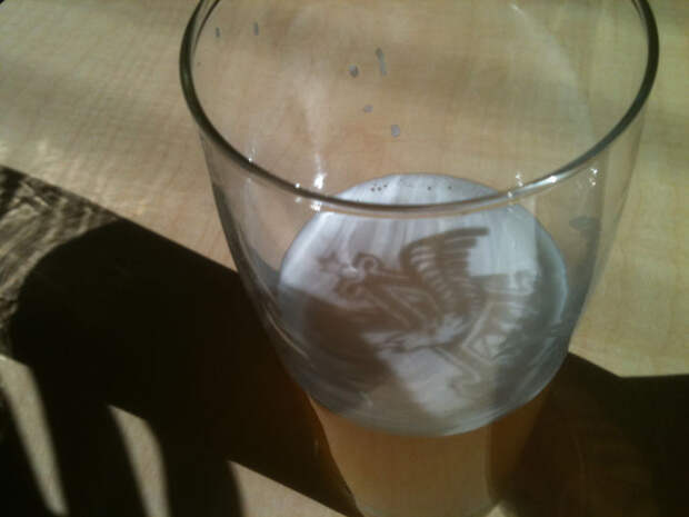 Sunlight Cast A Shadow Of The Glass's Logo Onto My Beer