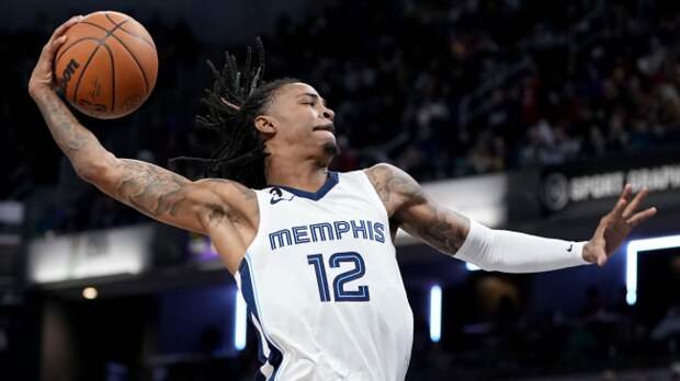 Ja Morant dunks the basketball.