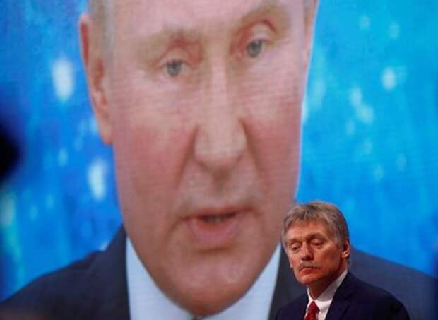 Kremlin spokesman Dmitry Peskov sits in front of an electronic screen during Russian President Vladimir Putin's annual end-of-year news conference, held online in a video conference mode, in Moscow, Russia December 17, 2020. REUTERS/Maxim Shemetov