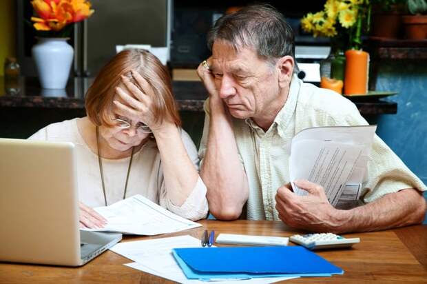 Two people looking at papers at a desk.