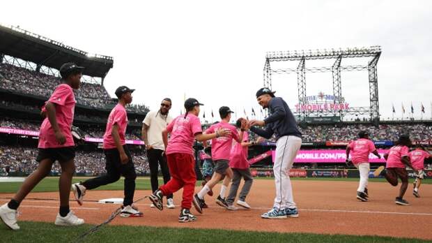 Kids run onto the field at the Home Run Derby.