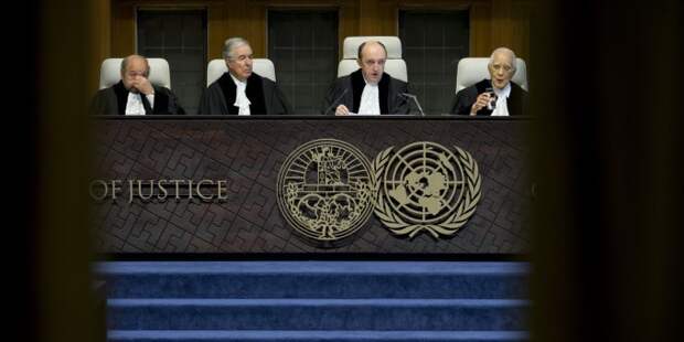Presiding judge Peter Tomka, second right, of Slovakia starts reading the World Court's decision in The Hague, Netherlands Tuesday, Feb. 3, 2015 as the International Court of Justice, the United Nations' highest court, is ruling on whether Croatia and Serbia committed genocide during the wars sparked by the breakup off the former Yugoslavia in the 1990s. Croatia has accused Serbia of genocide early in the wars and Serbia in turn claims that Croat forces were responsible for genocide in a 1995 campaign to retake territory held by rebel Serbs. Other judges, from left, are; Ronny Abraham of France, Bernardo Sepulveda-Amor of Mexico, Tomka and Hisashi Owada of Japan. (AP Photo/Peter Dejong)