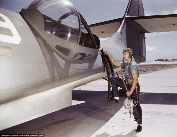 Aviation Ordnance Mate Jesse Rhodes Waller prepares to install a .30-caliber machine gun in a Navy PBY plane