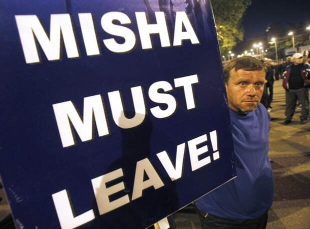 An opposition supporter holds a banner during a rally in Tbilisi