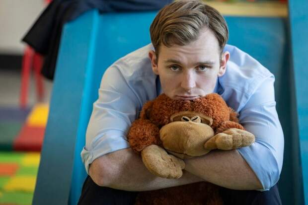 Robert pouts with a stuffy.