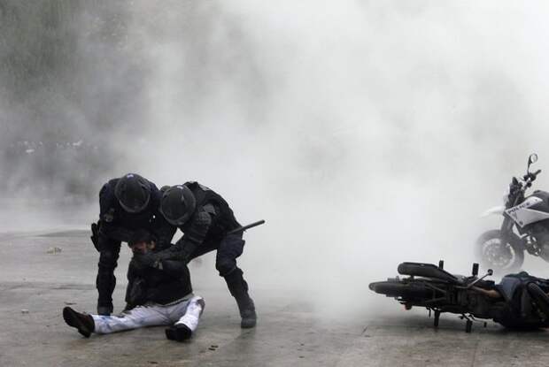 A protester is detained by the special 