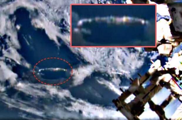 Длинный сигарообразный НЛО скрывается в облаках ниже МКС