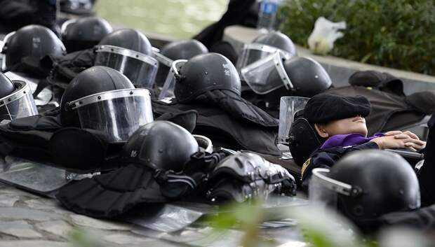 Thai riot police take a nap in Dusit Zoo as they enjoy some free time during a lull in demonstrations in downtown Bangkok