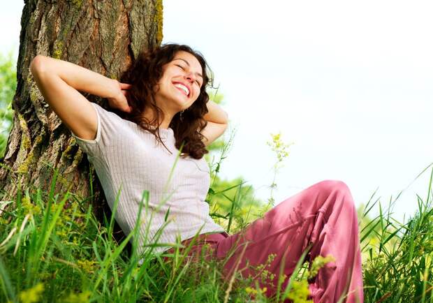 Beautiful Young Woman Relaxing outdoors. Nature