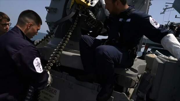 Heavy weaponry: Personnel get to grips with one of HMS Defender¿s formidable guns. They are pictured handling ammunition for one of the guns