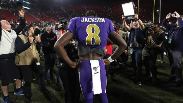 Lamar Jackson being photographed on the field