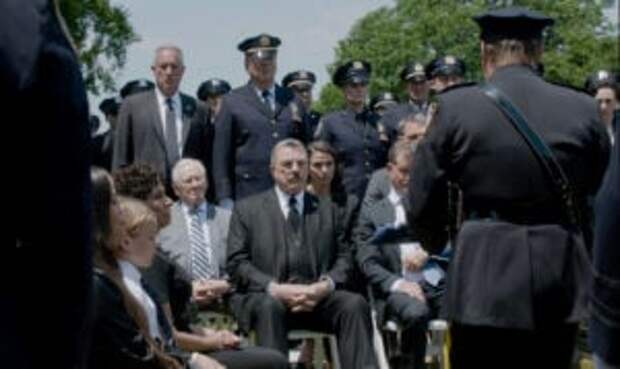 The Reagans listen to a eulogy on Blue Bloods Season 14 Episode 18