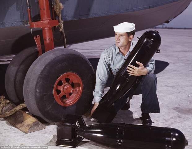 J.D. Estes loads munitions into a plane in the stunning photos that re-emerged this week 