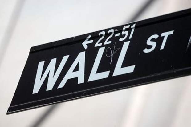 The Wall St. sign is seen near the New York Stock Exchange (NYSE) in New York City, U.S., March 29, 2021. REUTERS/Brendan McDermid