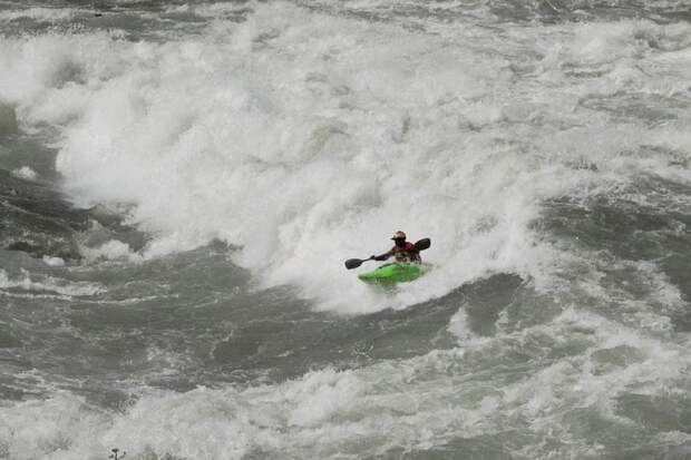 Sadat Kawawa paddles over The Dead Dutchman rapid on the White Nile river in a kayak.