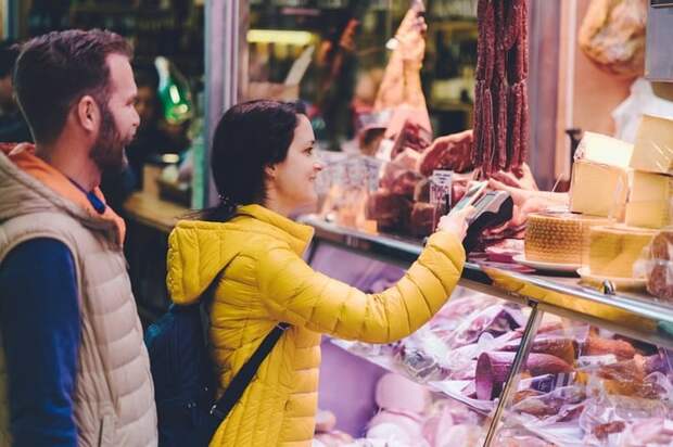 Couple using credit card at farmers market