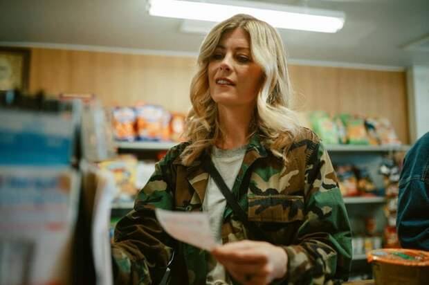 Consumer buying lottery ticket inside convenience store.