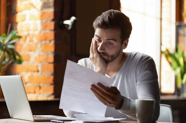 Stressed Out Guy Looking At Paper