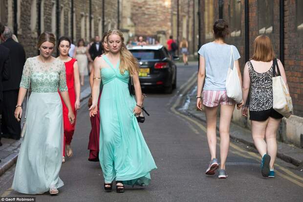 Members of the public stroll past as revellers finally start making their way to the lavish all-night event on Monday evening