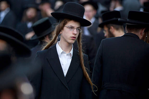 An Ultra-Orthodox Jew attends a prayer as he and others gather in the religious neighborhood of Mea Shearim to protest against summer events organized by the city council, Jerusalem