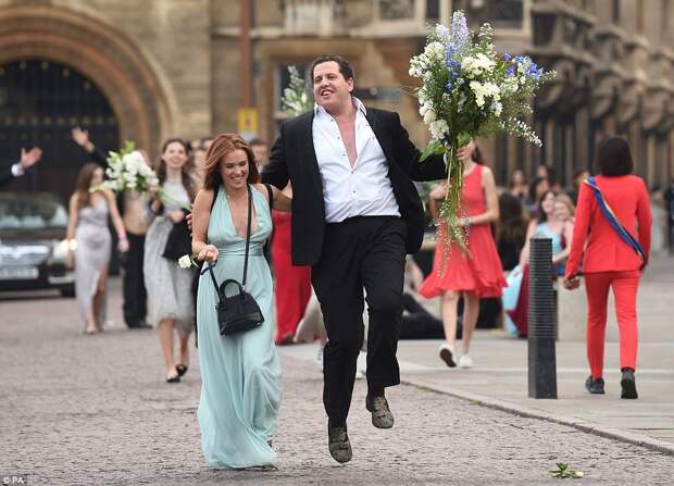 Jumping for joy: One excitable guest and his female friend can't hide their joy as they leave the all-night party